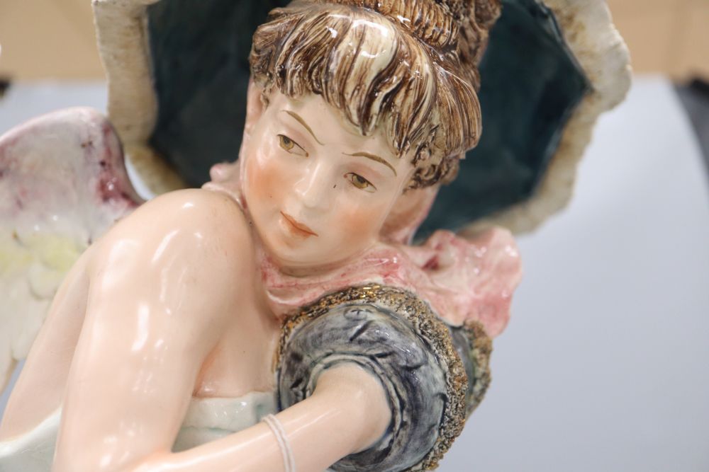 A Continental large pottery figure of a winged nymph,